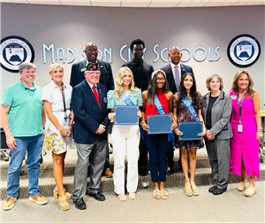 boys and girls state students posing with board members at front of meeting