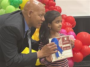 Assistant superintendent Eric Terrell posing with student winner