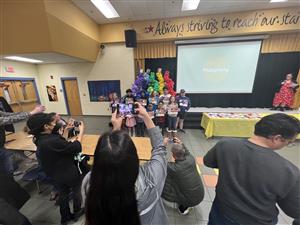 parents taking photos of kids on stage