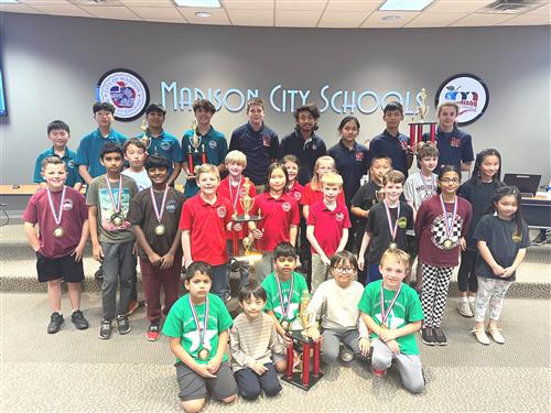 group pic of chess members in front of board room