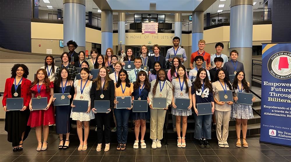 Photo of graduating seniors from the class of 2025 with their Seal of Biliteracy medals and certificates