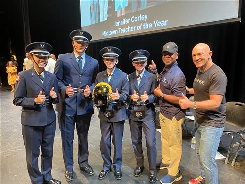 John Foley posing with ROTC members