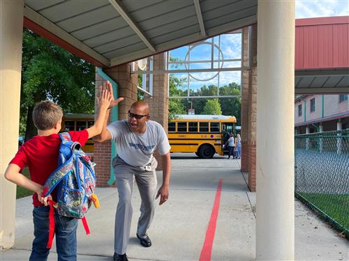 Eric Terrell greeting student