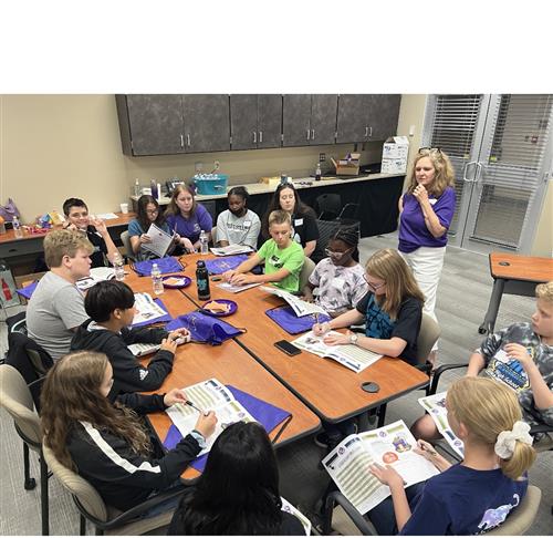 students around a table discussing ideas to welcome military students