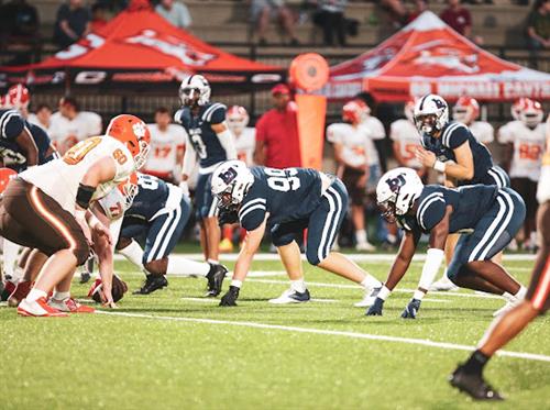 Football players lined up in formation against each other. Bob Jones vs Grissom