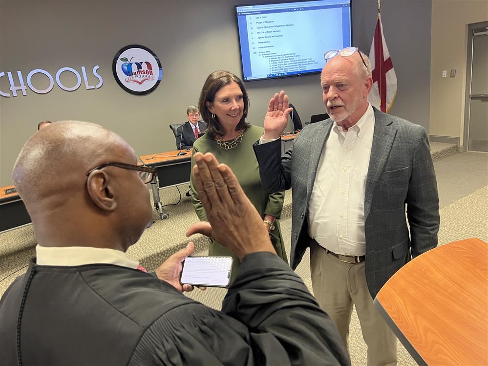  Tommy Overcash being sworn in by judge with wife looking on