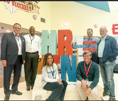 all five boe members in front of school with Dr. Nichols