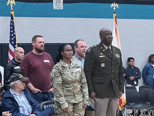 veterans standing to be recognized in the Discovery Middle gym