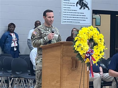 soldier in uniform speaking to gym at Discovery Middle about serving in the Army