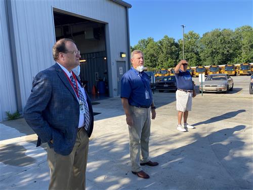 Dr. Nichols shown with Transportation Coordinator John Wilson at bus lot 