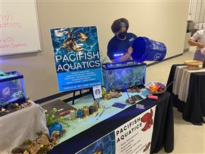 student in front of an aquarium