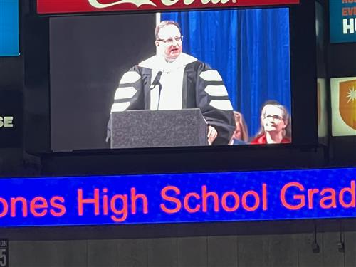 Dr. Nichols on jumbo screen delivering remarks