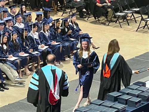 BJ graduate walking across stage for diploma