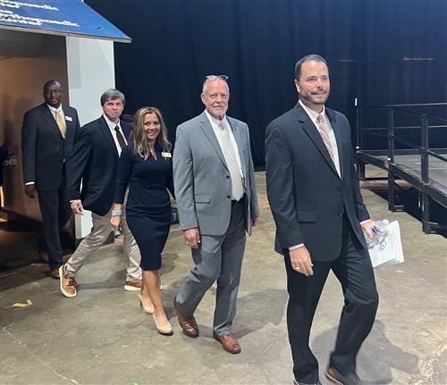 five board members walking out in procession