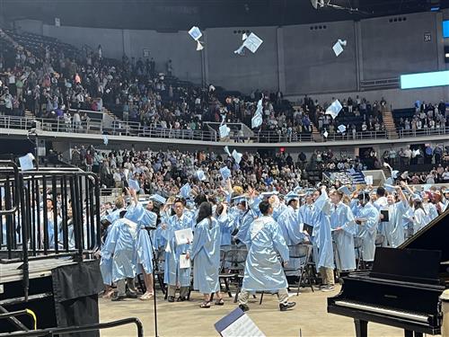 graduates tossing caps