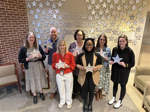 7 teachers holding stars