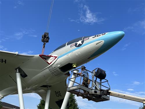 jet on pedestal with scaffolding welder underneath