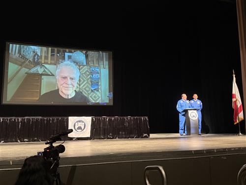 Local author Homer Hickam on screen behind Dr Nichols and Mr. Terrell
