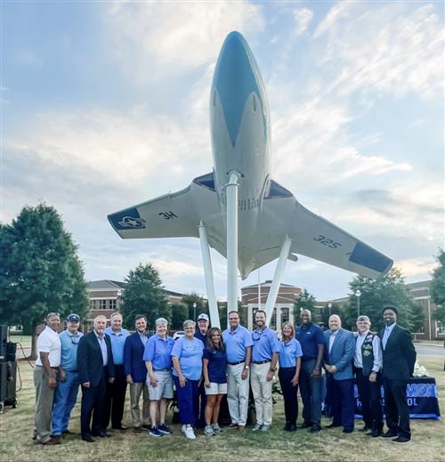 jet with dignitaries in foreground