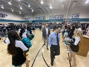 VIPs entering gym between cheerleaders