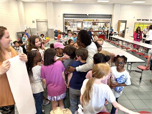 teacher surrounded by students