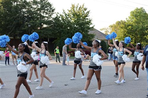 girls with pom poms marching