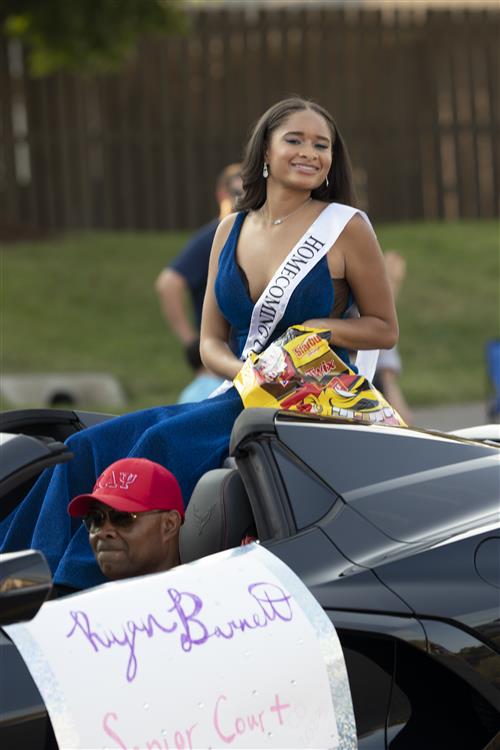 Homecoming attendant riding in convertible
