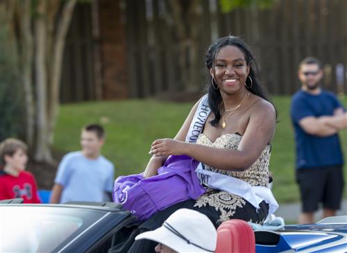 homecoming contestant in convertible