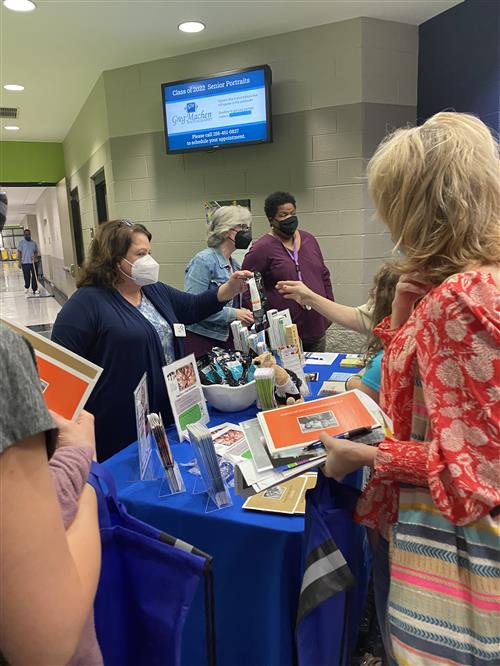 Parents getting handouts at a drug prevention group table