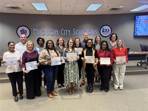  teachers holding their certificates up