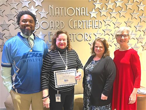 Carol Torello counselor at Rise Academy holding certificate