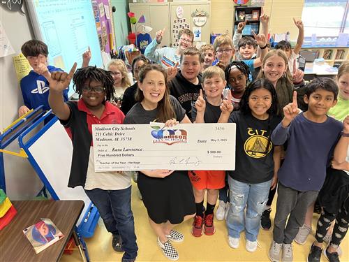 teacher surrounded by students at Heritage elementary